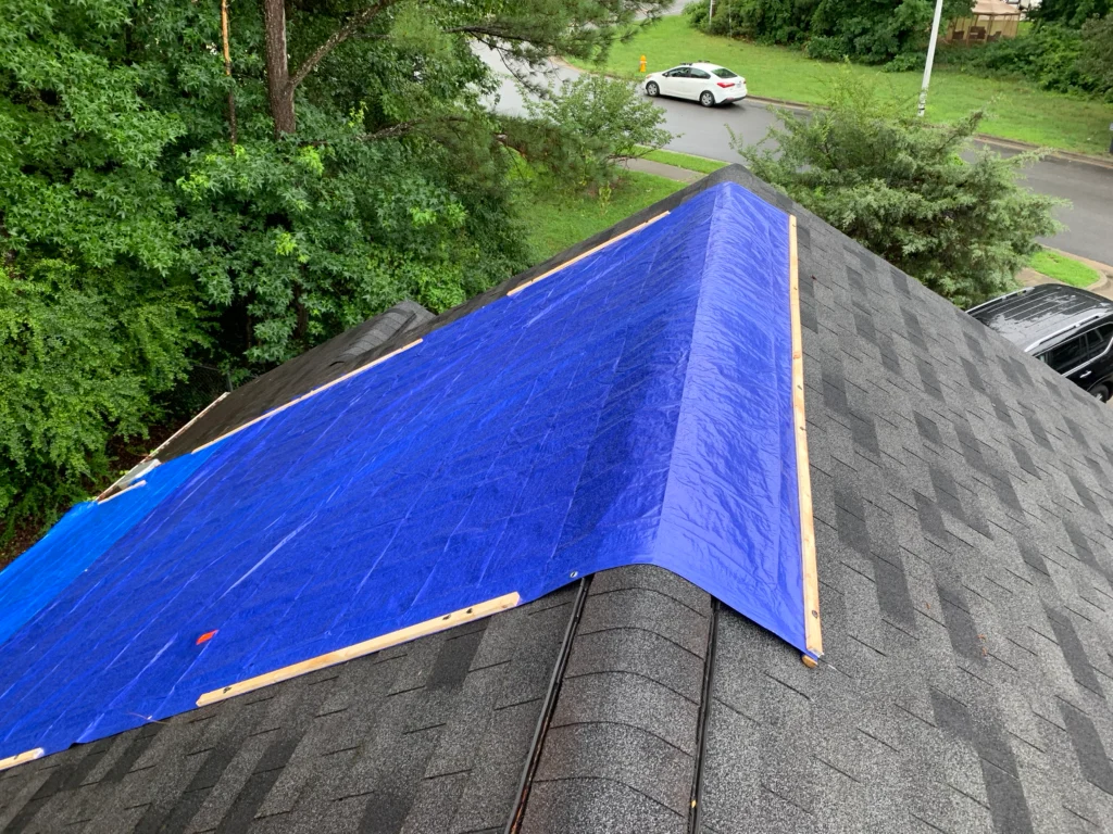 Emergency tarping roofing expert working on home in East York