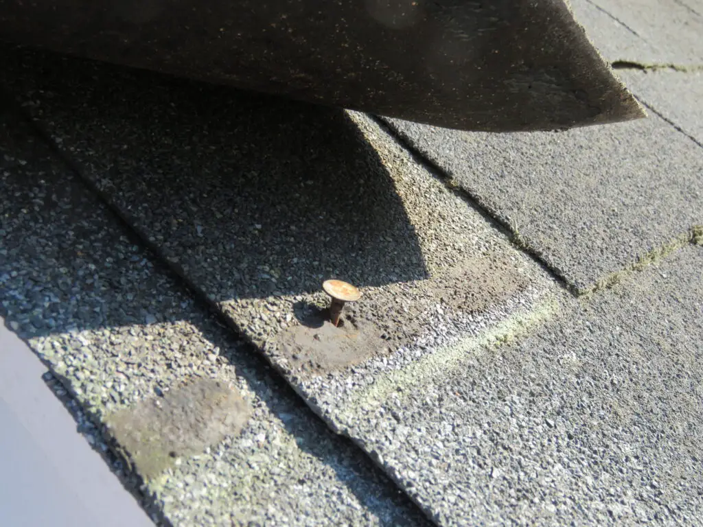 Nail pops & exposed fasteners asphalt shingles installation in Edmonton home