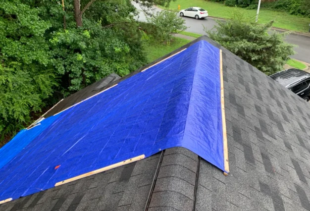 Emergency tarping roofing expert working on home in East York