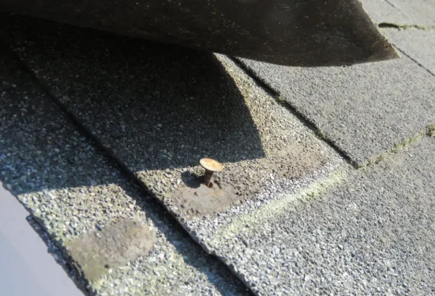 Nail pops & exposed fasteners asphalt shingles installation in Edmonton home